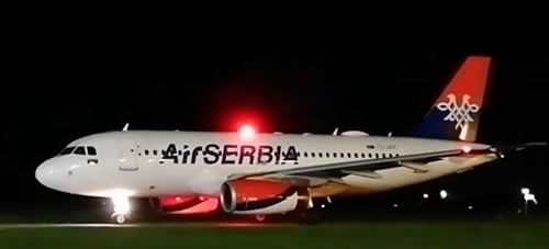 Air Serbia airliner with taxi lights illuminated