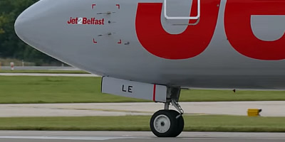 Airliner registration number on the nosewheel door on the front landing gear